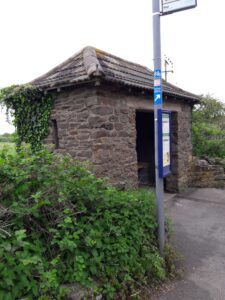 alt="stone bus shelter"