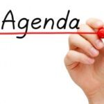 alt="hand writing agenda link to meeting agenda"