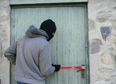 alt="criminal breaking in through door"