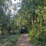 alt="tractor in woods"