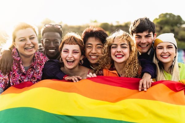 alt="people with pride flag"