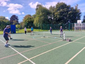 alt="regular players in a game of pickleball"